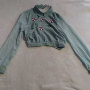 A mint green long sleeve shirt